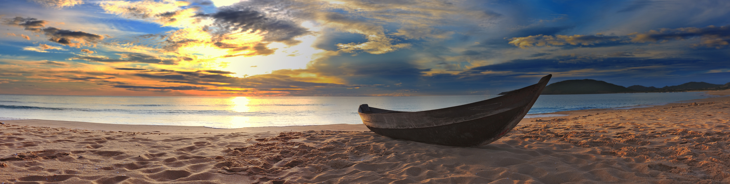 photo of a canoe sitting on a beach