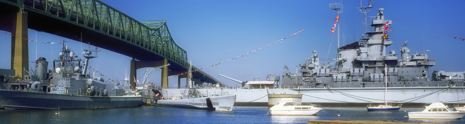 Battleship Cove in Fall River MA with bridge and lots of boats