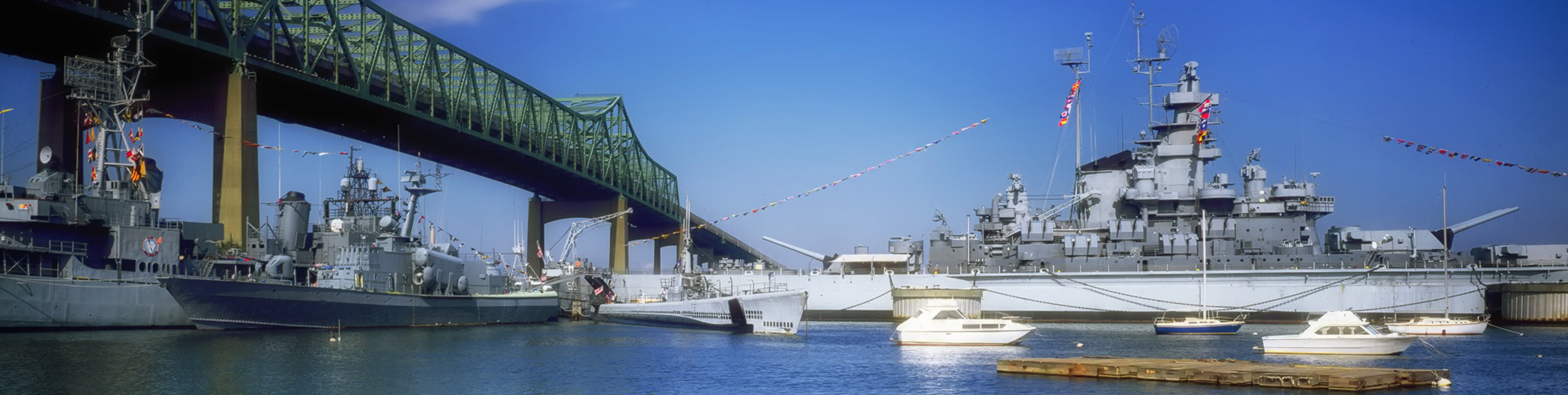 Battleship Cove in Fall River MA with bridge and lots of boats