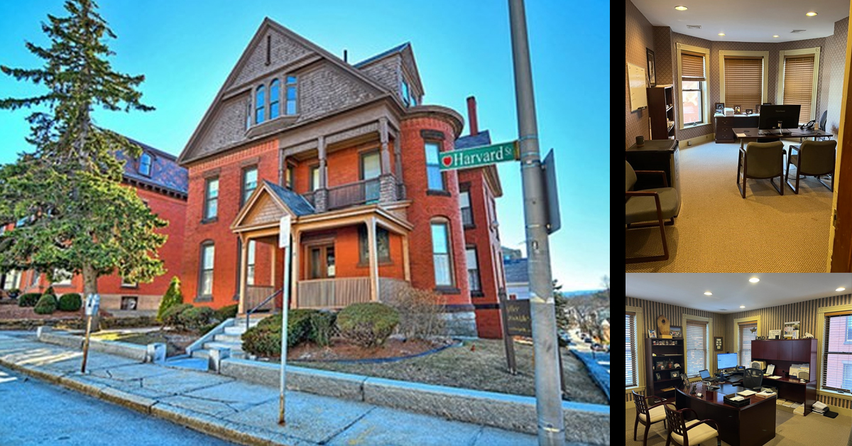 large brick multi level building with Harvard Street sign out front