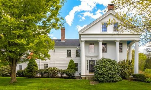 white residence with 4 columns over the main entrance