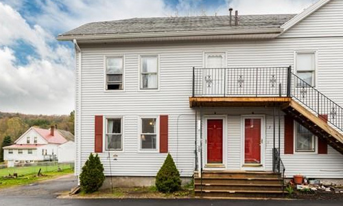 white residence with red shutters and doors