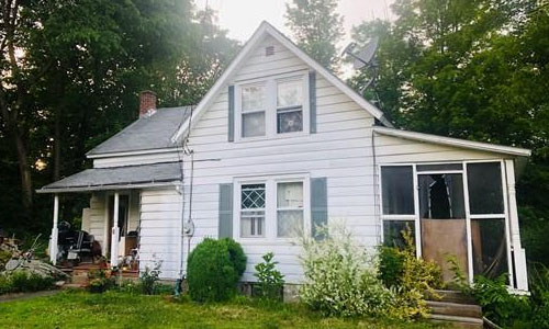 Detached White Cape with screened porch on right