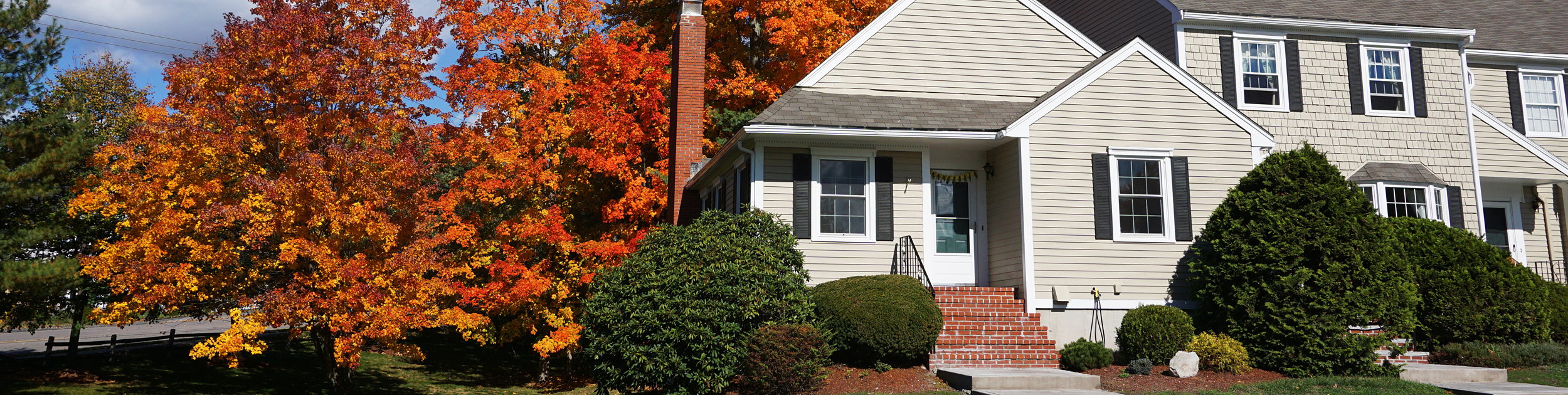 beautiful home with Fall foliage surrounding it