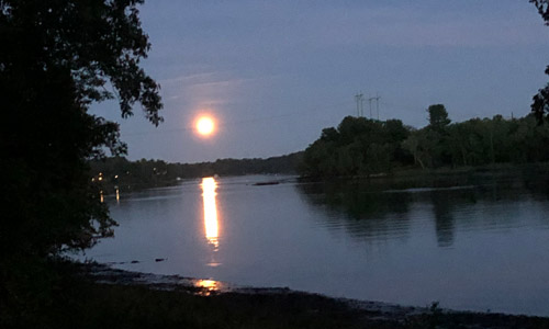 Riverfront home for sale in Merrimac, moon over the river shown