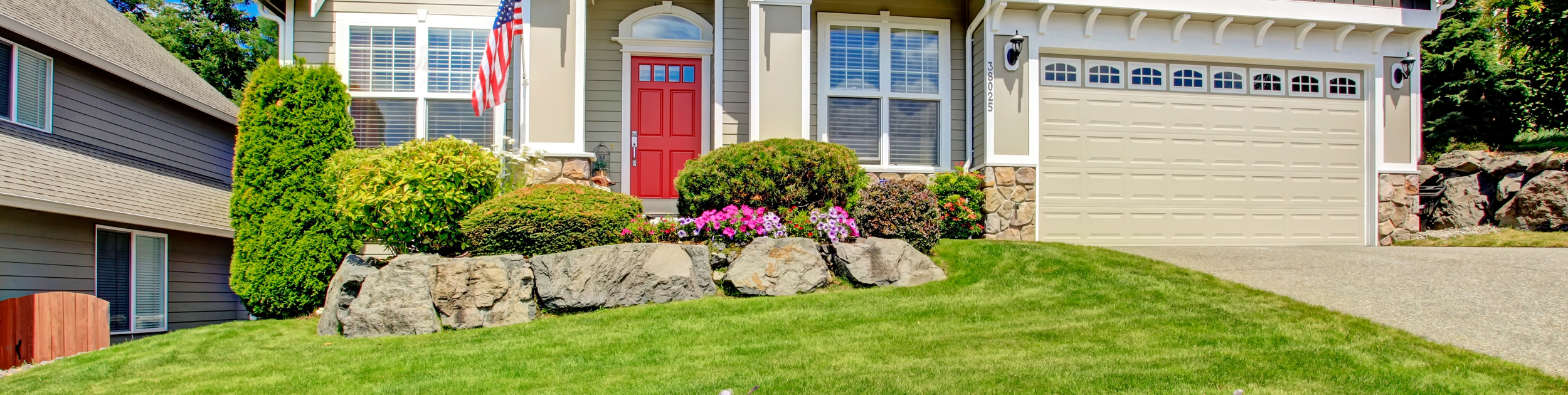 luxury home with Spring bushes blooming outside